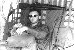 Flight Engineer John McCloy sitting in airacraft 034.