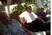 Sy Berdux, Herman Bullard, and Rodney Brown sitting in the Lobby during Reunion 2002 registration. Royce Raley's reflected image can be seen in the mirror over Herman Bullard's right shoulder behind the plants taking the picture.